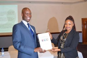 MISA Malawi chairperson Thom Khanje presenting the Golden Key Award to Malawi Electoral Commission (MEC) Press Officer Chikondi Mvula